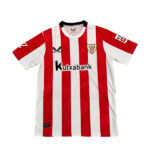 Soccer jersey with red and white vertical stripes, featuring the sponsor 'Kutxabank' and a club crest on the chest.