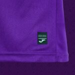 Close-up of purple fabric with a small dark green tag reading 'ORIGINAL PRODUCT / PRODUCTO ORIGINAL' and a white logo below.