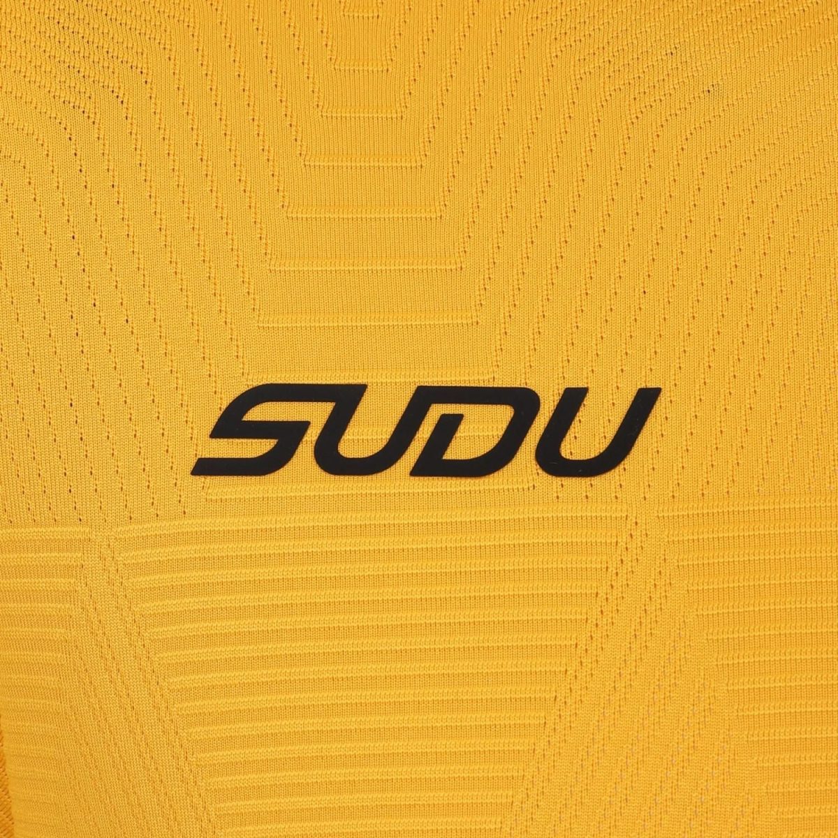 Close-up of yellow knitted fabric featuring a black 'SODU' logo.