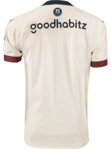 Back-of-PSV-Eindhoven-Away-Shirt-23-24_d93caa5a-1725-4821-8329-1e0fec8ea1bf | UAE SPORT STORE Back view of a cream-colored athletic jersey with the sponsor text 'goodhabitz' across the upper back and a circular crest at the neckline, maroon sleeve cuffs visible.