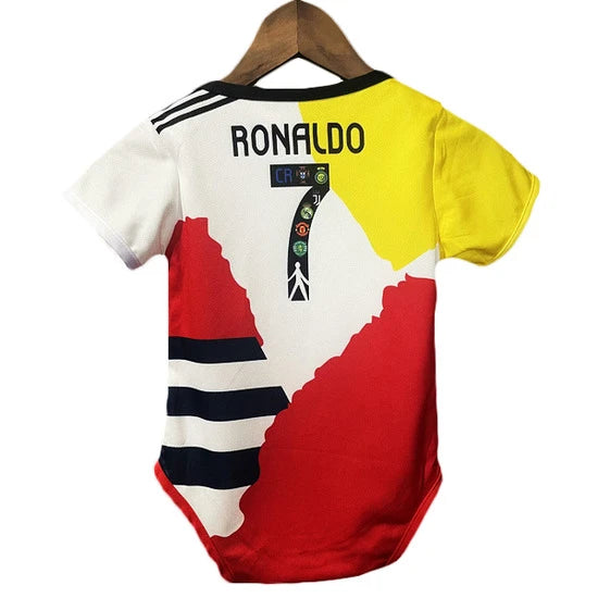 Baby onesie featuring a Ronaldo-themed soccer jersey print with the number 7, in red, white, yellow, and black, hanging on a wooden hanger.