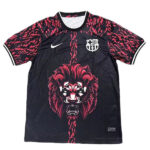 Black Nike football jersey with pink patterned sleeves, Barcelona crest, and a red roaring lion graphic down the center.