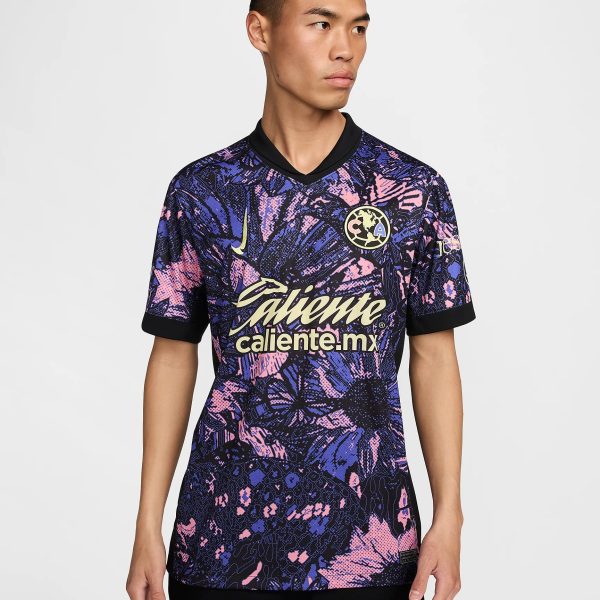 Male model wearing a purple-pink abstract-patterned soccer jersey with the 'caliente.mx' logo across the chest.