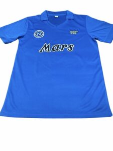 Blue sports jersey with Mars logo across chest and round emblem on left chest, short sleeves, polo collar.