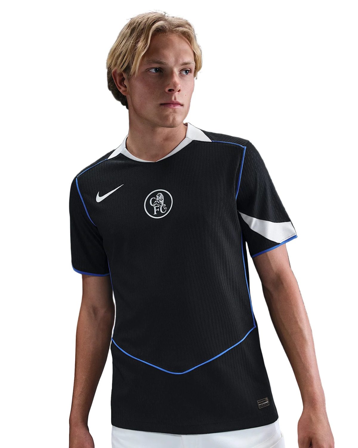 Young man in a black athletic jersey with white collar and blue piping, looking to his left, crest visible on chest