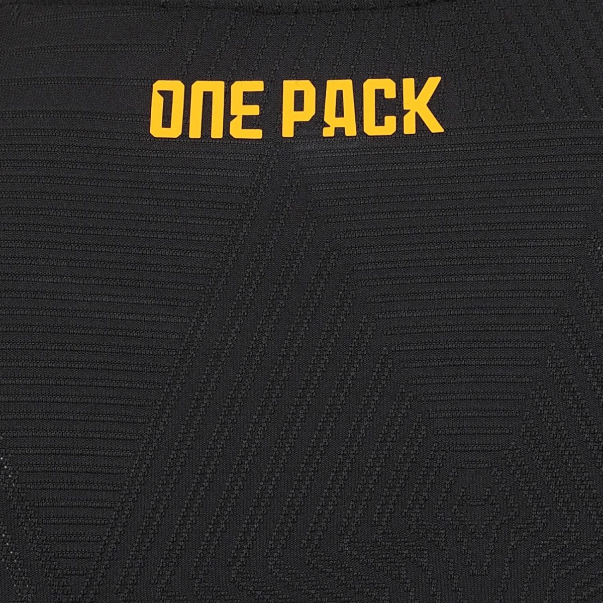 Orange 'ONE PACK' lettering on a black, textured fabric background (close-up).