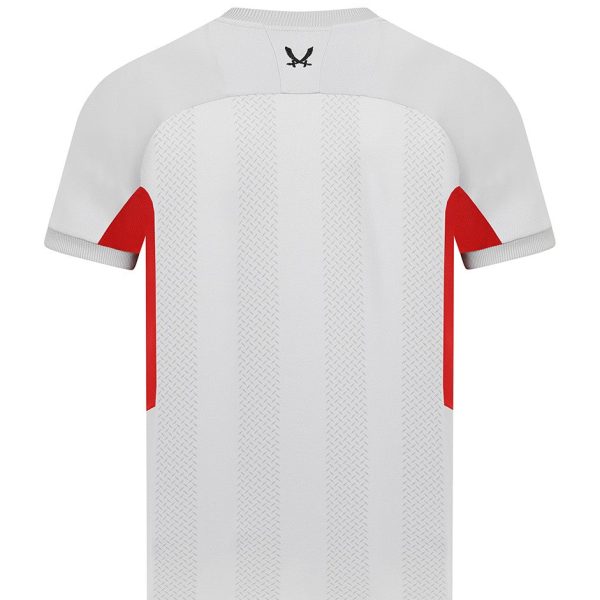 White soccer jersey with subtle vertical stripes, red side panels, and a small black logo on the back neck.