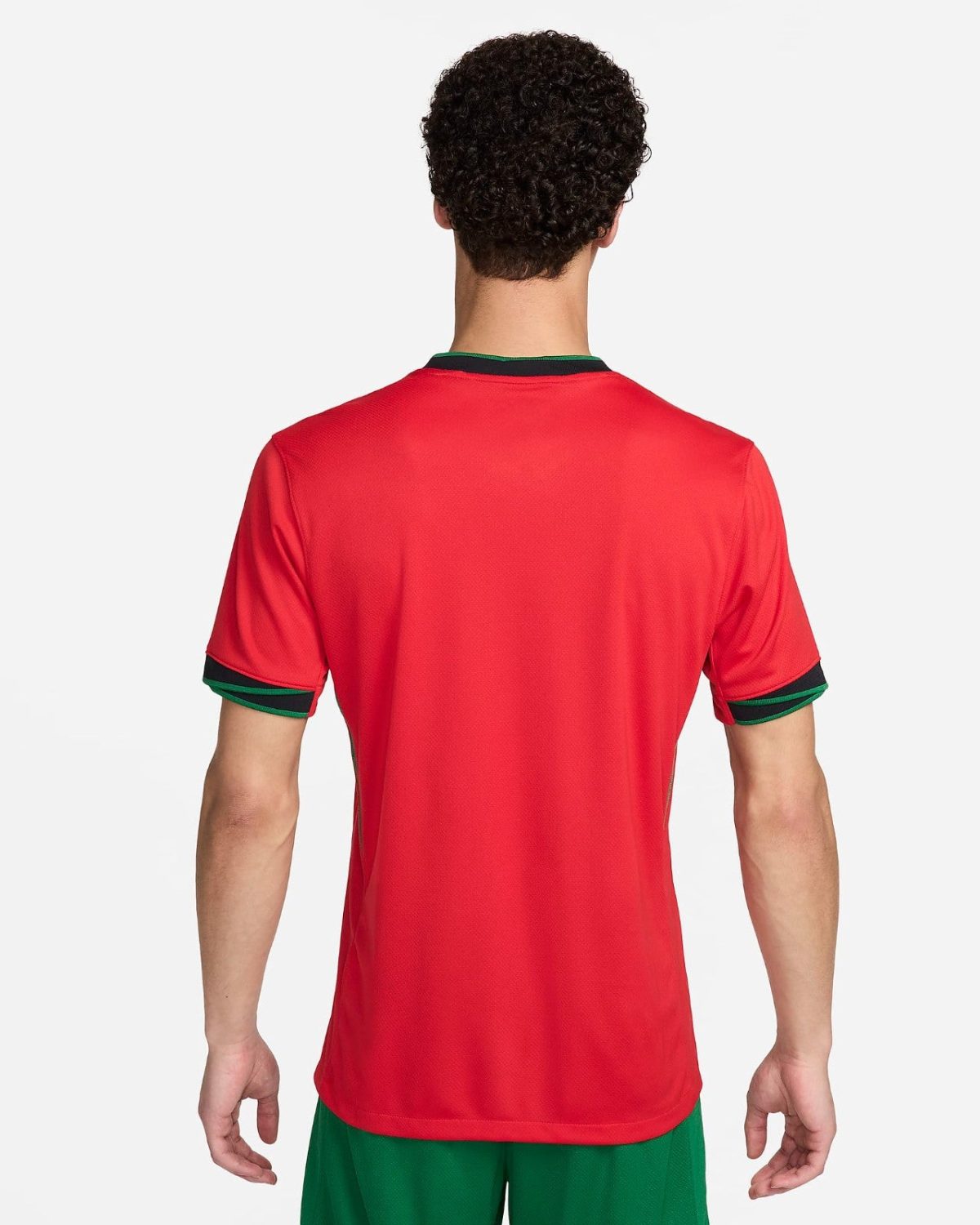 Back view of a person wearing a red athletic shirt with green trim at the collar and sleeve cuffs, paired with green shorts.