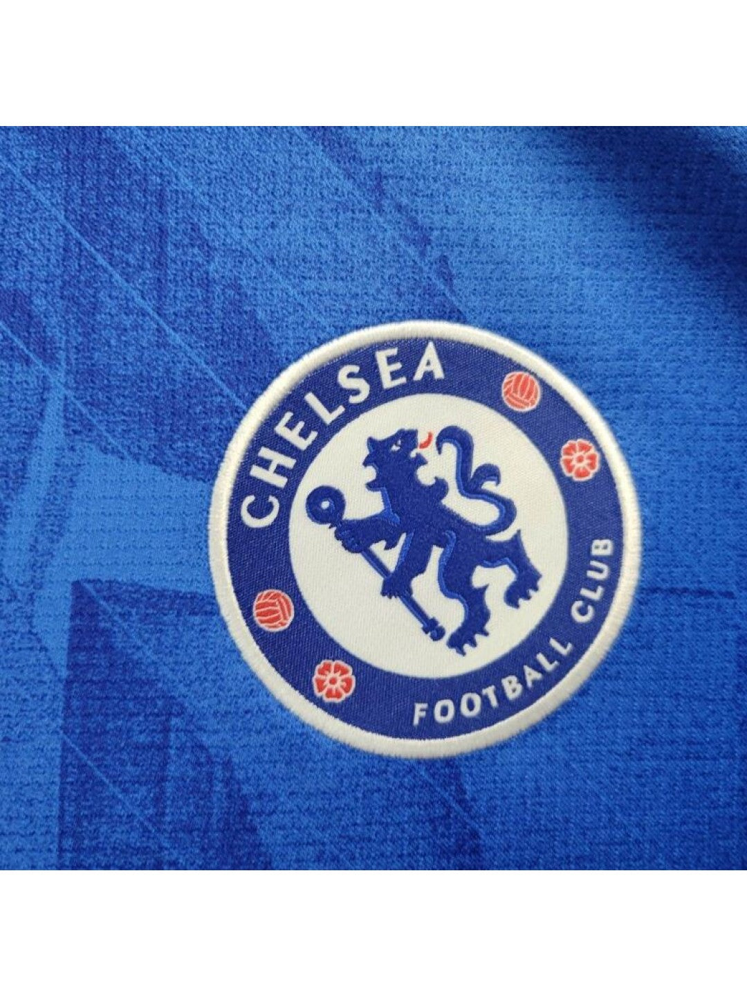 Camiseta-Chelsea-FC-1_-Equipacion-2526camisetafutboles_3-1080x1440-1 | UAE SPORT STORE Chelsea Football Club circular logo on blue fabric background with a white inner circle and blue lion emblem.