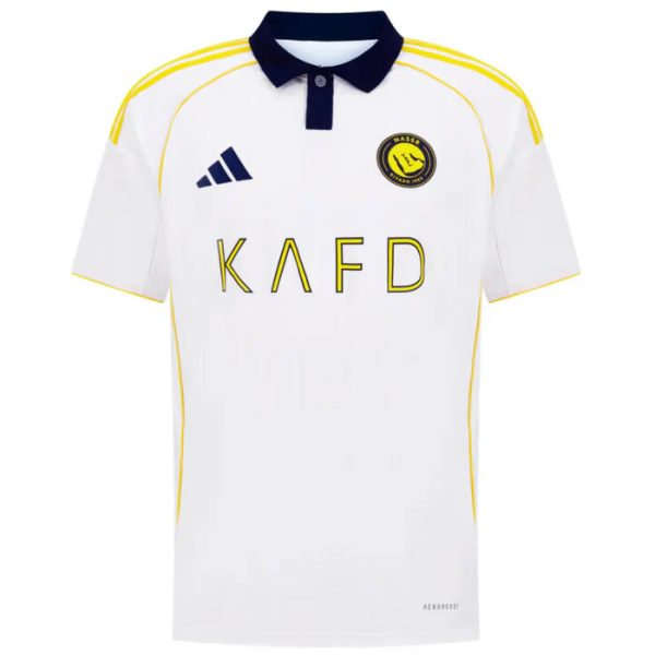 White soccer jersey with a navy collar and yellow piping; features KAFD sponsor text, Adidas logo, and a club crest on the chest.