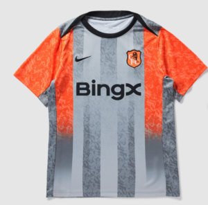Soccer jersey with orange sleeves and gray vertical stripes, featuring a BingX sponsor logo and club crest on the chest.