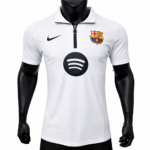 White FC Barcelona jersey on a mannequin with Nike swoosh, club crest, and a large Spotify logo on the chest area.