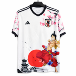 White Japan football jersey with pink cherry blossoms and a large Luffy illustration on the front.