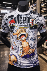 Mannequin wearing a white graphic T-shirt with One Piece art, 'ONE PIECE' lettering, and a JFA patch.