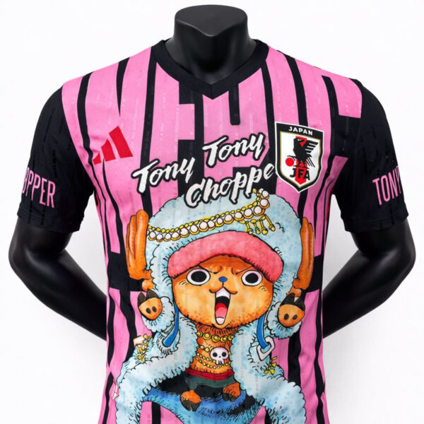 Colorful pink and black striped soccer jersey with a Tony Tony Chopper graphic, JFA crest, and a cartoon character in blue fur.