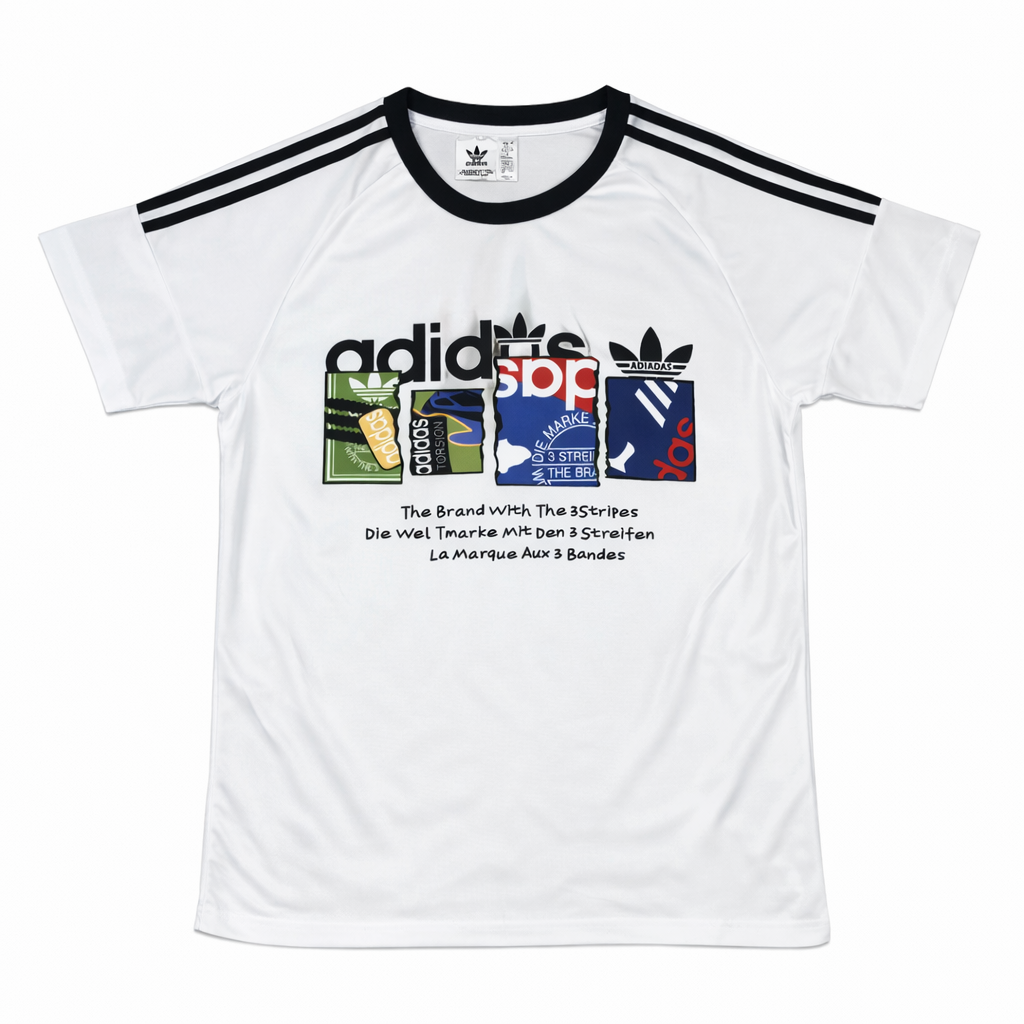 ChatGPT_Image_Jan_13_2026_07_23_38_PM White Adidas graphic T-shirt with black shoulder stripes, featuring a multicolored logo panel on the chest and multilingual slogan text beneath.