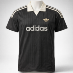 Black Adidas polo jersey with cream collar and cream stripes on shoulders, front logo and large 'adidas' text