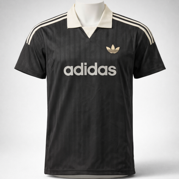 Black Adidas polo jersey with cream collar and cream stripes on shoulders, front logo and large 'adidas' text
