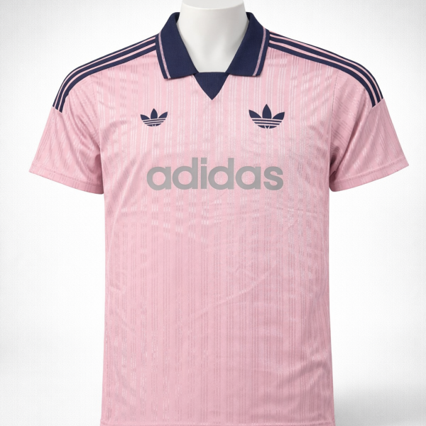 Pink Adidas jersey with navy collar, three navy stripes on shoulders, trefoil logos, and large 'adidas' branding across the chest.