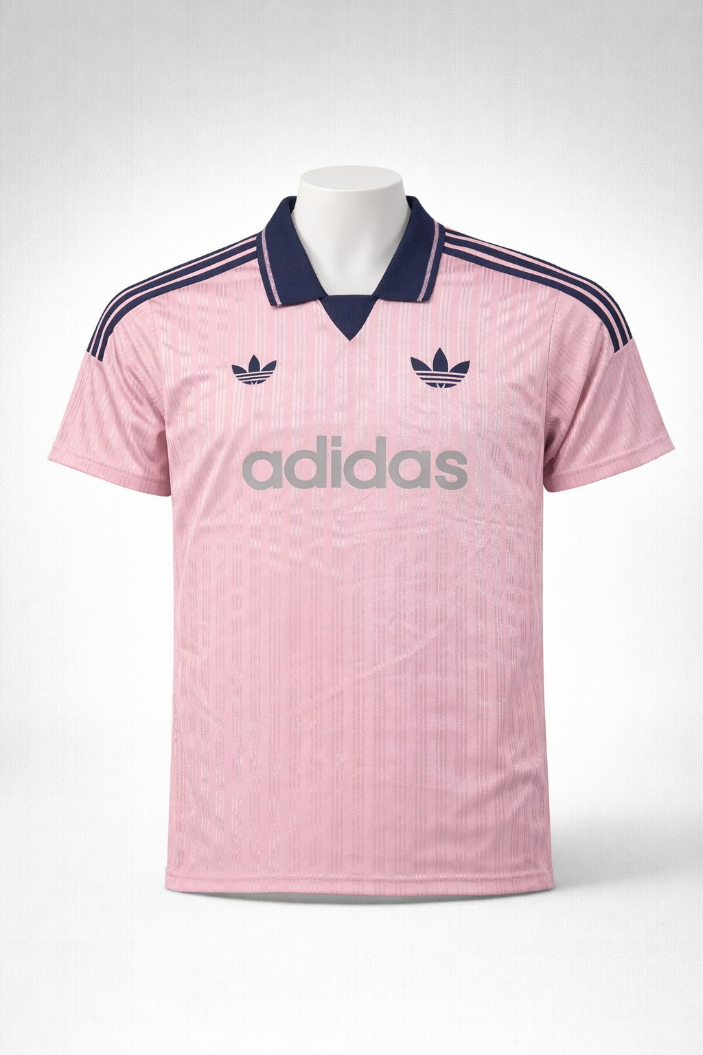 ChatGPT_Image_Jan_5_2026_10_54_38_PM Pink Adidas jersey with navy collar, three navy stripes on shoulders, trefoil logos, and large 'adidas' branding across the chest.