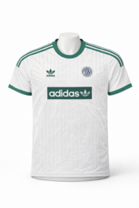 White Adidas soccer jersey with green accents, three green stripes on shoulders, sponsor logo 'adidas' across chest, team crest on left chest.