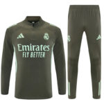 Real Madrid dark green training suit with Emirates Fly Better sponsor text and club crest on jersey; matching pants shown from front.