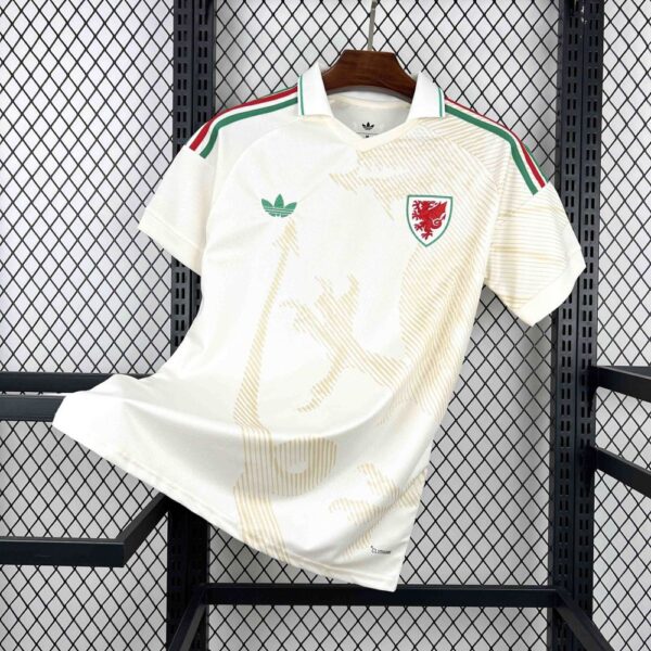 White Wales national team football jersey on a hanger, with green-red shoulder stripes and dragon crest.