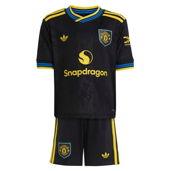 Manchester United football kit in black with yellow trim and Snapdragon sponsor on the jersey, plus matching black shorts with yellow stripes and crest.