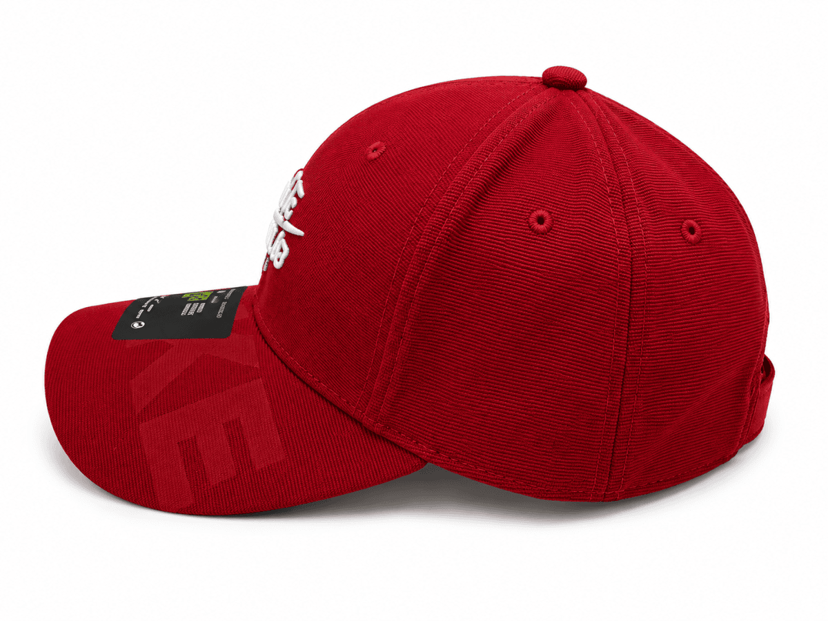 Red baseball cap with a curved brim, white embroidery on the front panel, and a black label on the brim tip.