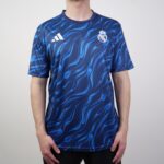 Man wearing a blue patterned Real Madrid jersey with Adidas logo on the chest area.