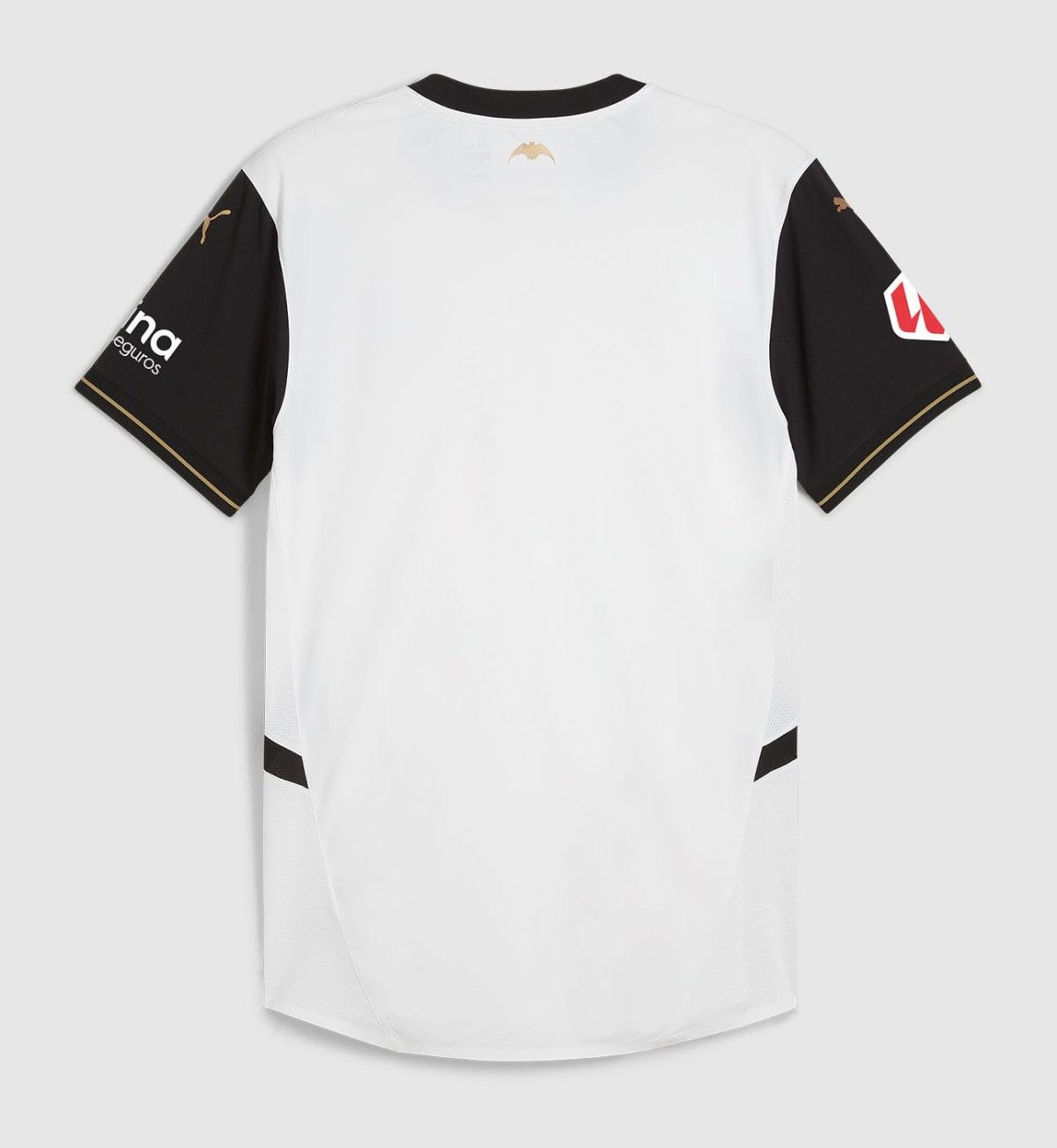 Back view of a white athletic jersey with black sleeves and gold trim accents on the cuffs and shoulders photographed against a gray background.