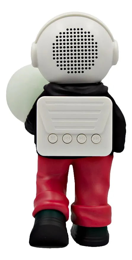D_NQ_NP_2X_846610-MLM105765654343_012026-F-bocina-lampara-led-inalambrica-astronauta-balon-futbol | UAE SPORT STORE Back view of a toy astronaut with a white speaker backpack, red pants, black shoes, holding a pale green disc.