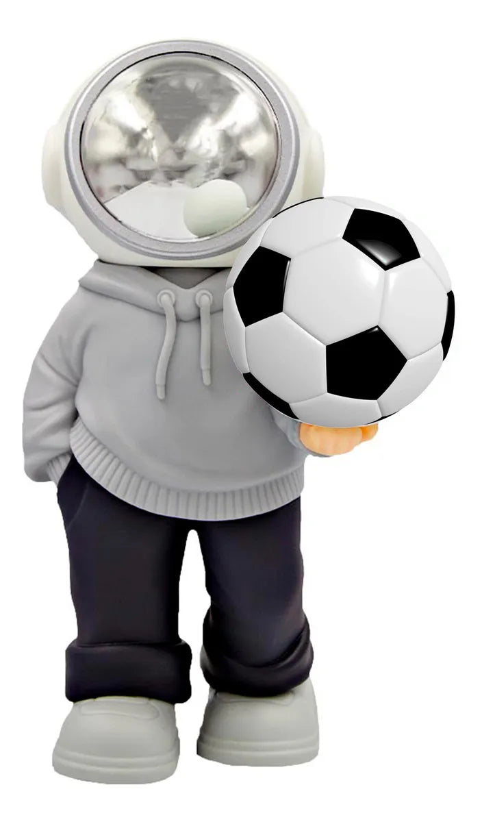 D_NQ_NP_2X_994951-MLM105766453241_012026-F-bocina-lampara-led-inalambrica-astronauta-balon-futbol | UAE SPORT STORE Toy astronaut figure in a gray hoodie holding a black-and-white soccer ball