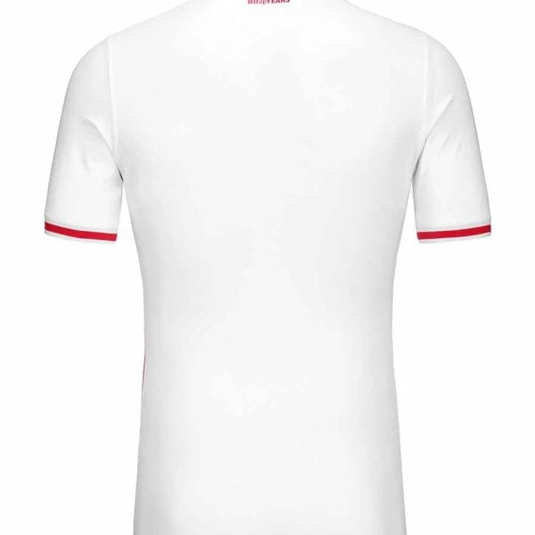 White polo shirt seen from the back with red piping on the collar and sleeve cuffs; small red '100 YEARS' logo at the neckline.