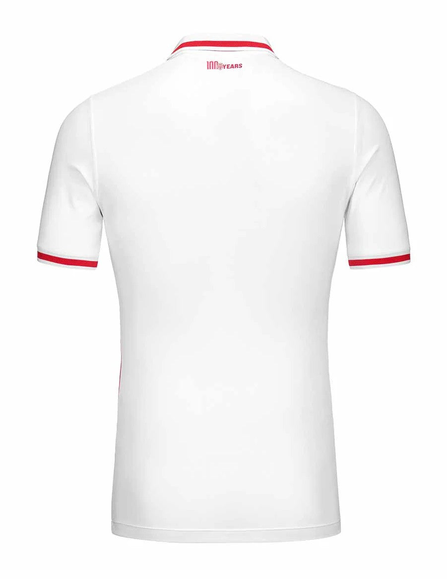 DbQ7A5YF7GB4b1R | UAE SPORT STORE White polo shirt seen from the back with red piping on the collar and sleeve cuffs; small red '100 YEARS' logo at the neckline.