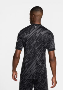 Dz2WUNLPBn7l1mx_ff5564d0-f4db-4d7e-b17a-d7836959a245 | UAE SPORT STORE Man wearing a black and gray patterned athletic jersey, shown from the back, with rolled cuffs and a small logo near the neckline