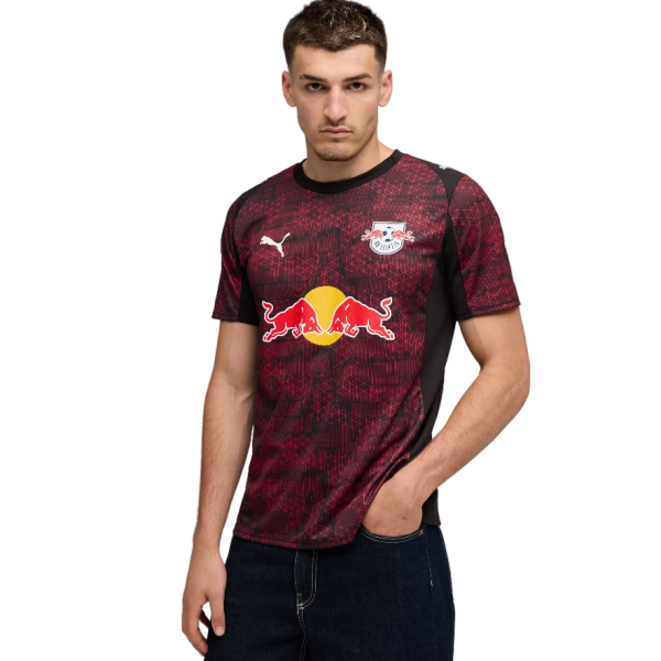 Man wearing a maroon RB Leipzig football jersey with Red Bull logo on the front, standing with one hand in his pocket.