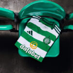 Green-and-white Celtic FC jersey draped over a bright green chair, sponsor 'dafabet' logo visible.