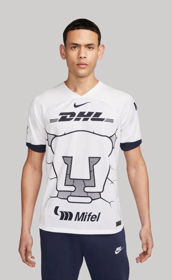 EwiMBdF43IlvF9S_fac58c3d-87b1-4fb5-863e-71122c646785 | UAE SPORT STORE Front view of a man wearing a white graphic sports jersey with DHL logo and a large U-shaped design on the chest.