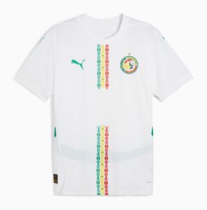 White soccer jersey with a green Puma logo on the left and the Senegal Football Federation crest on the right, centered by vertical multicolored diamond stripes.