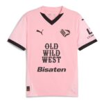 ExQsNcQuHHrEQ8X | UAE SPORT STORE Pink sports jersey with black V-neck, Puma logos, and bold text 'OLD WILD WEST' on front; appears to be a football (soccer) jersey.