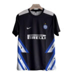 Inter Milan soccer jersey on a hanger featuring the Pirelli sponsor, Nike swoosh, and team crest against a black base with gray shoulders and blue diagonal panels.