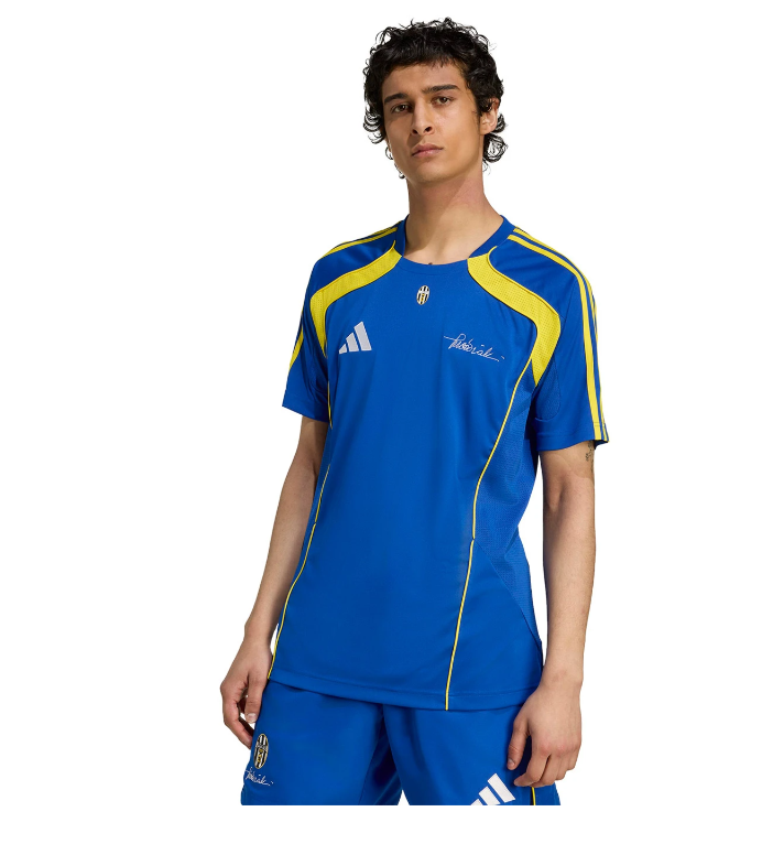 F | UAE SPORT STORE Young man in a blue athletic jersey with yellow piping and matching shorts, Adidas logo on chest, standing against a white background.