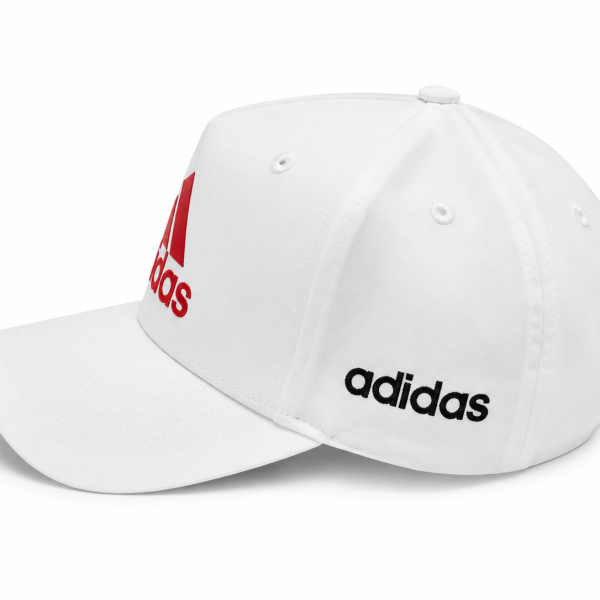 White Adidas baseball cap with a red logo on the front and black Adidas text on the side, curved brim facing left.