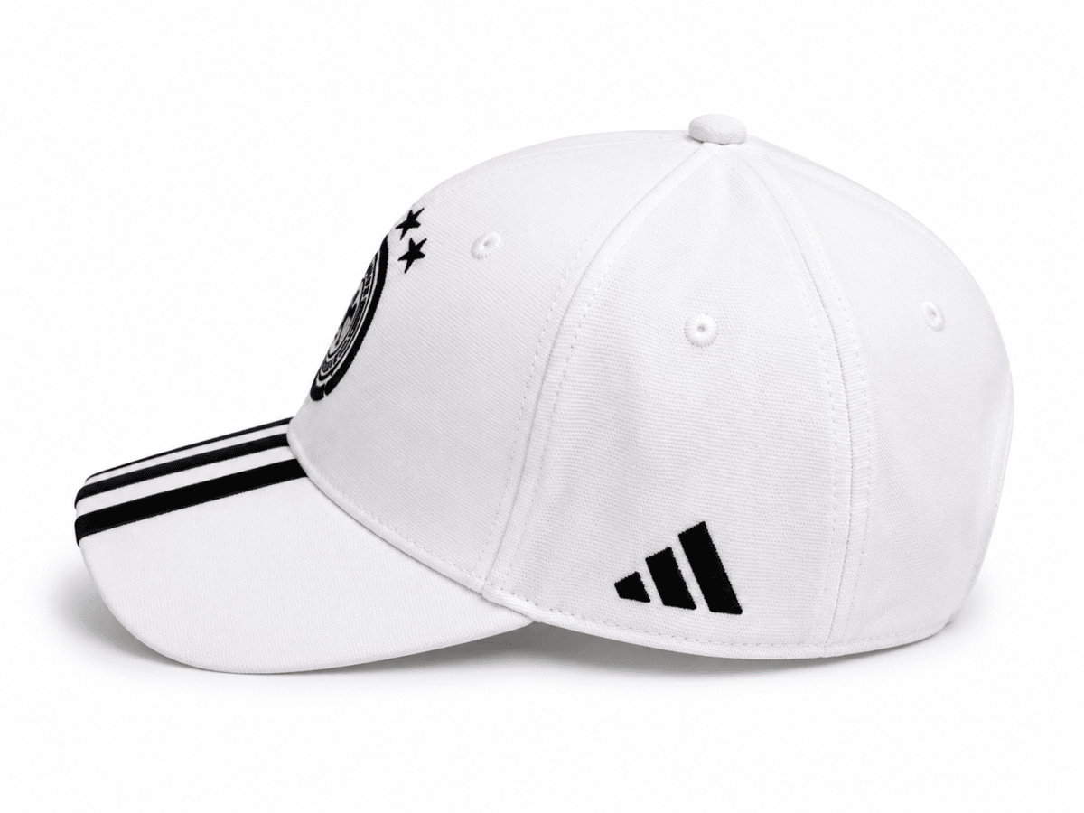 White baseball cap with black stripes on the brim and an Adidas logo on the side edge.
