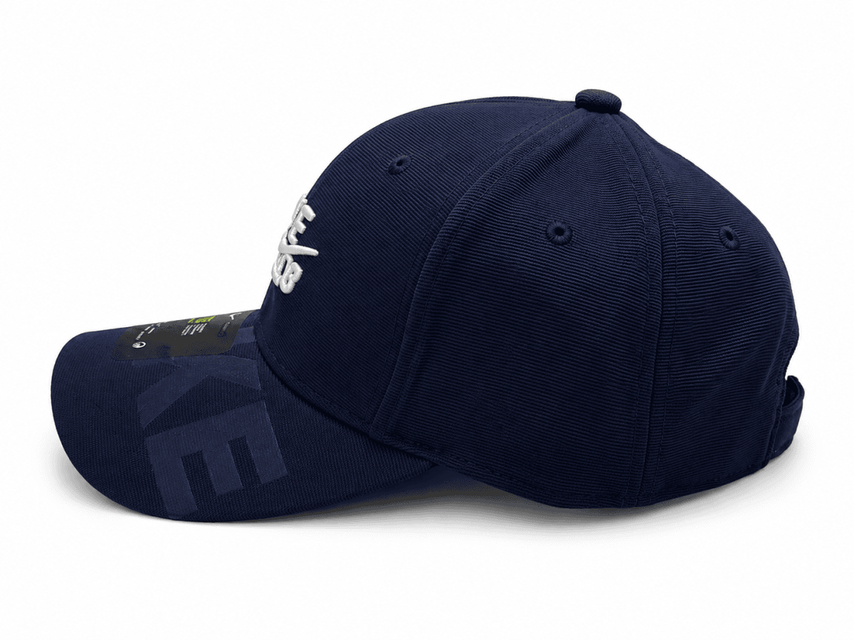 Navy blue baseball cap with white embroidered text on the front and curved brim, viewed from the side/front angle.
