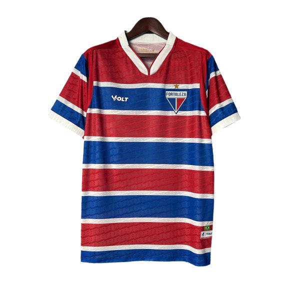 Red and blue striped Fortaleza football jersey with white trim on sleeves and collar, featuring the club crest on the chest and a Volt logo.