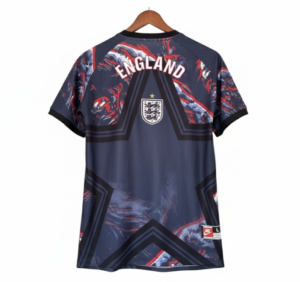 Back view of an England national football jersey on a wooden hanger: dark navy with red/white abstract patterns, large 'ENGLAND' text across the shoulders, and a crest near the upper back.