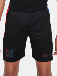 Black athletic shorts with red and blue side panels; crest on the left leg and Nike swoosh on the right leg.
