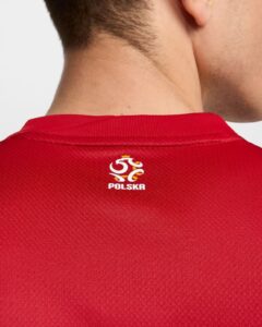Back view of a person wearing a red sports jersey with the Poland (Polska) crest on the upper back near the collar